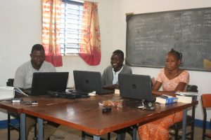 Three members of the Birifor Firs t Bible translation team at work.